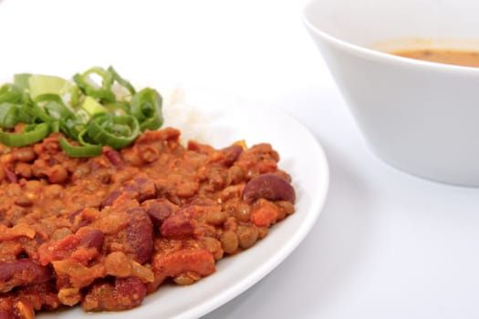 Indian legume hash with rice on a white background