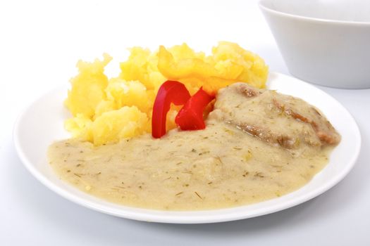 Seitan with dill sauce and potatoes on a white background