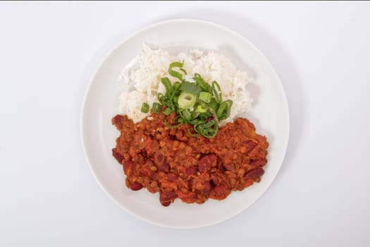 Indian legume hash with rice on a white background