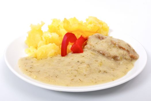 Seitan with dill sauce and potatoes on a white background