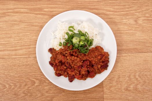 Indian legume hash with rice on a wooden table