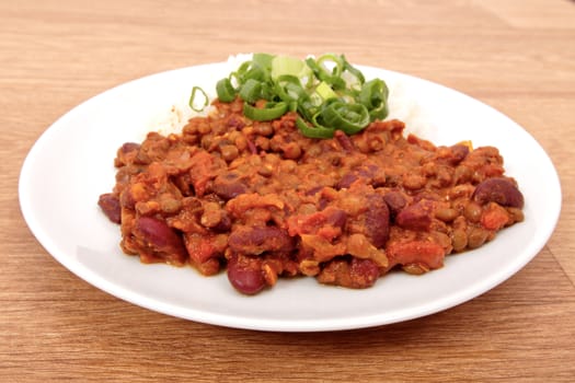 Indian legume hash with rice on a wooden table