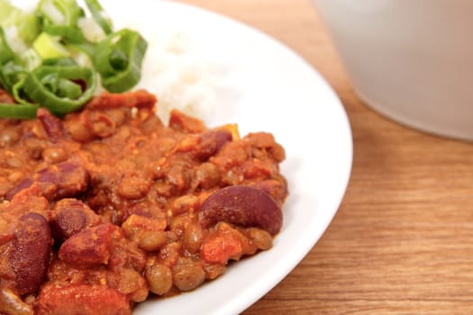 Indian legume hash with rice on a wooden table