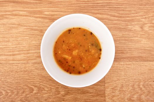 Oyster mushroom soup with vegetables on a wooden table