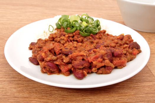 Indian legume hash with rice on a wooden table