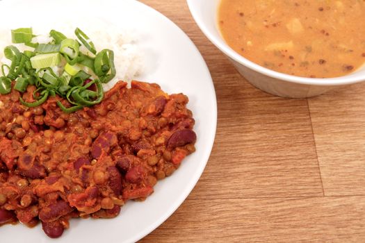 Indian legume hash with rice on a wooden table