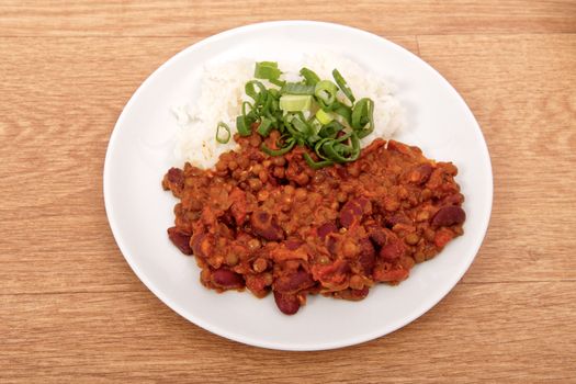 Indian legume hash with rice on a wooden table
