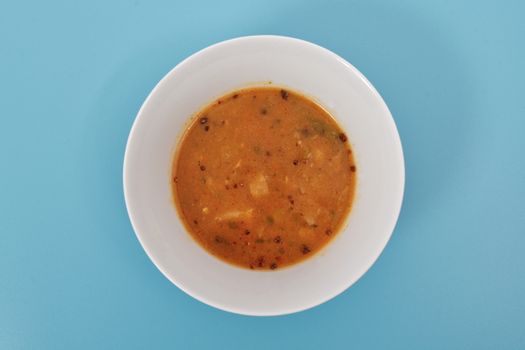 Oyster mushroom soup with vegetables on a blue background