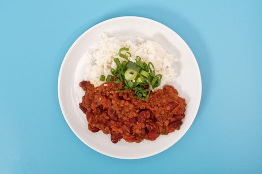 Indian legume hash with rice on a blue background