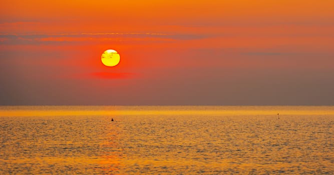 Scenic view of beautiful bright sunset above the sea surface