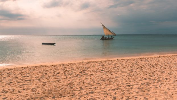 Traditional Fisherman's Dhow boat sailing in sunset.Zanzibar, Tanzania,used split toning.