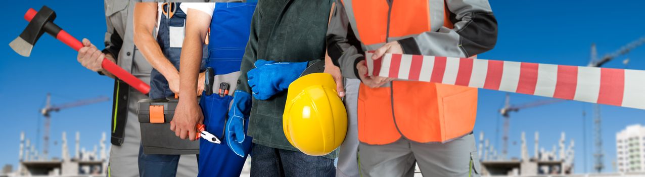 Many workers closeup with equipment on building background