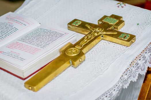 Church utensil on an altar, cross and the Bible on table ceremony of christening