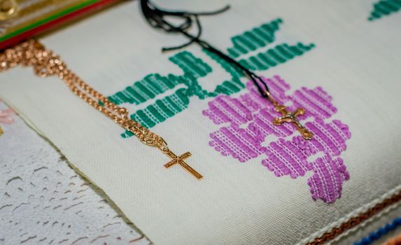 Two golden crosses for church christening on embroidary