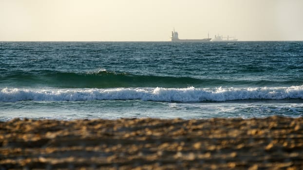 seascape, view from shore to waves and ship