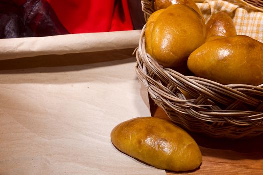 Wicker basket with fresh sintered pies on the table