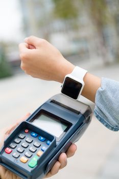 Customer using smart watch to checkout