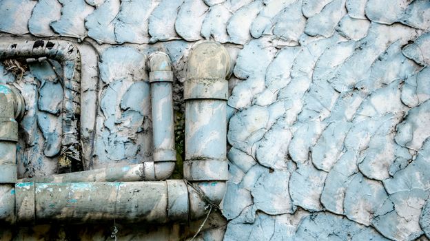 Old Dirty Water Pipes on Vintage Painted Wall Texture - Blue/ Teal Pastel. Outside local house in the countryside Thailand.