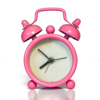 Miniature Vintage Pink Alarm Clock - Minimal Design. Beautiful Pastel Color. Isolated with real shadow reflected on white.