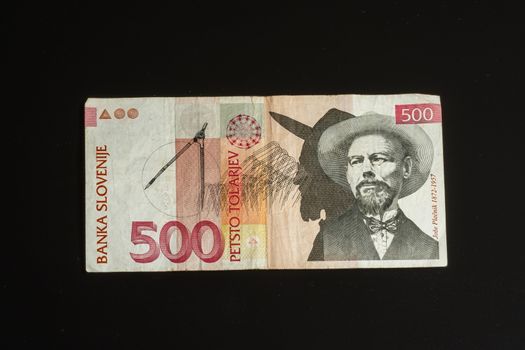 Obsolete 500 tolar bill of Slovenia, became obsolete with introduction of Euro currency, isolated on black background
