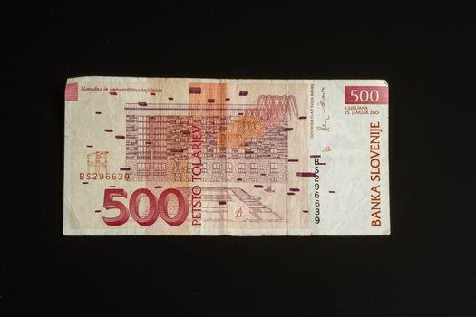 Obsolete 500 tolar bill of Slovenia, became obsolete with introduction of Euro currency, isolated on black background