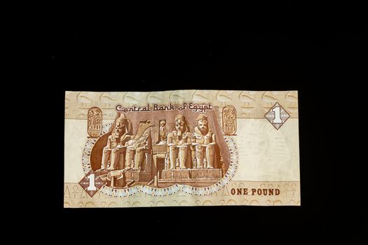 Egyptian banknote, Temple of Ramses II at Abu Simbel, one Egyptian Pound, close up, isolated on black background