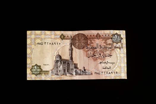 Egyptian banknote, Temple of Ramses II at Abu Simbel, one Egyptian Pound, close up, isolated on black background