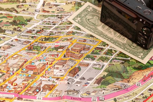Detail of travel map Flagstaff, Arizona, USA with camera and one Dollar bill, travel planning and preparation concept