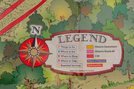 Closeup of travel map with legend and wind rose in form of a compass, travel concept, map detail