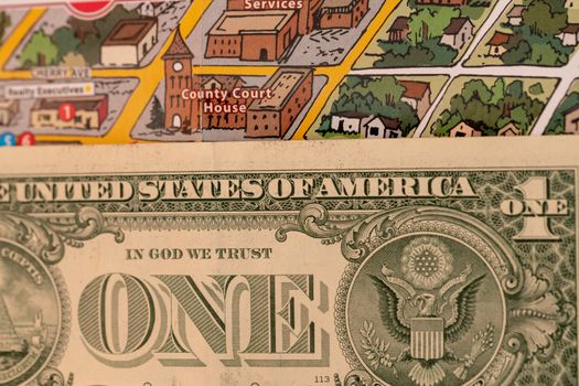 Detail of travel map Flagstaff, Arizona, USA with camera and one Dollar bill, travel planning and preparation concept, Dollar bill just below the couthouse, justice and travel concept