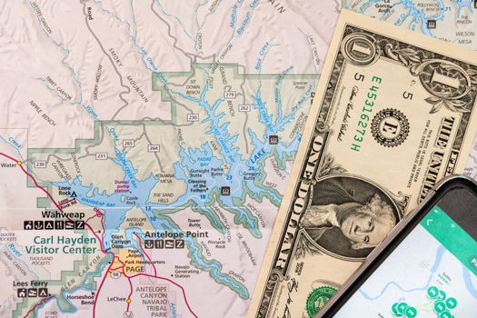 Travel planning with accessories, smart phone and travel map, detail of Arizona, USA map, travel preparation and planning concept to Lake Powell area and one Dollar bill