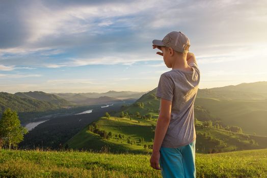 Young explorer at the sunset in Altai mountains