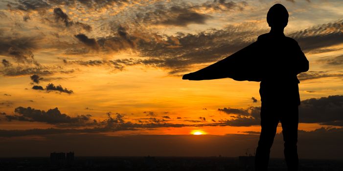 Silhouette of Super businessman at twilight in the city