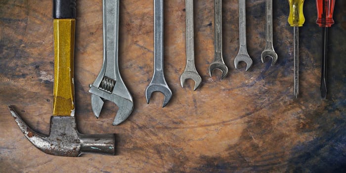 Set of hand tools on old cement background