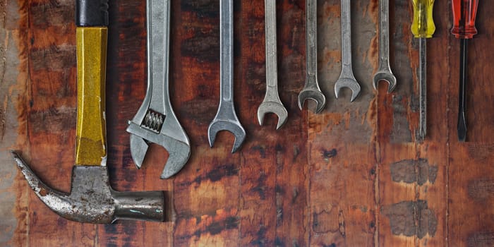 Set of hand tools on old wooden background