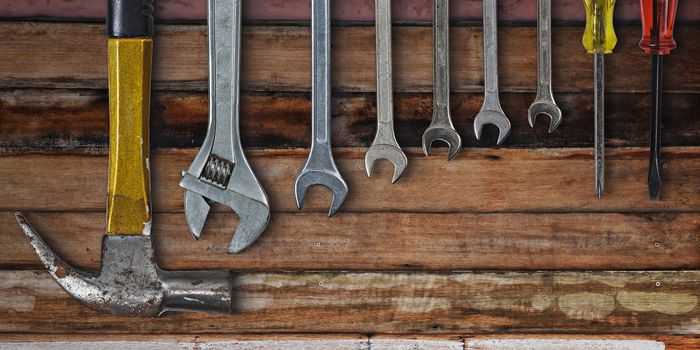 Set of hand tools on old wooden background