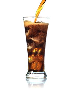 Cola is pouring into glass on white background