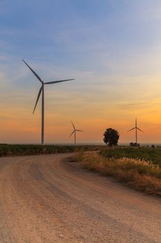 Wind turbine power generator farm at sunset