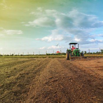 Farmer on tractor handles field