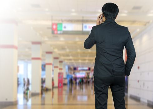 Attractive businessman using a cellphone on a modern office