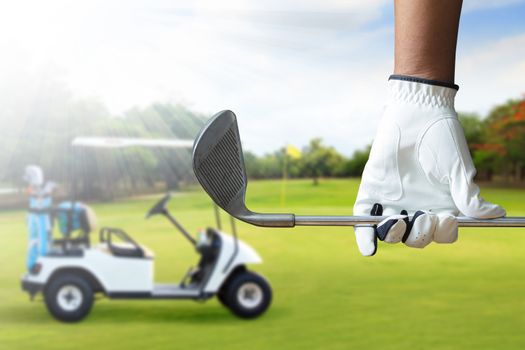 Golf player holding a golf club in golf course