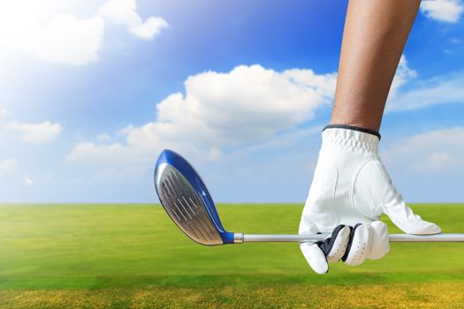 Golf player holding a golf club in golf course