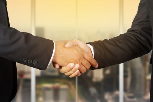 Businessman handshake, Successful businessmen handshaking in a modern office blurred background