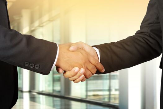 Businessman handshake, Successful businessmen handshaking in a modern office blurred background