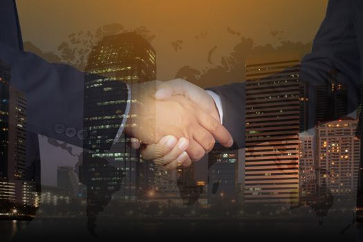 Double exposure of Businessman handshake, Successful businessmen handshaking in a modern office blurred background