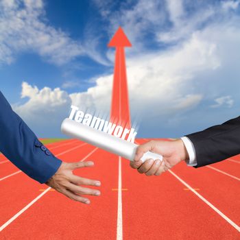 Cropped hand of businessman passing relay baton to colleague, the concept of teamwork for business success on running track