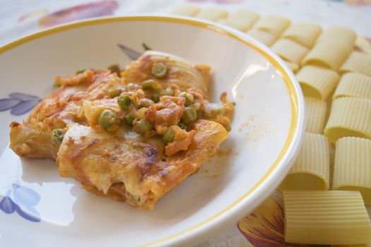 dish of baked pasta near grains of paccheri 