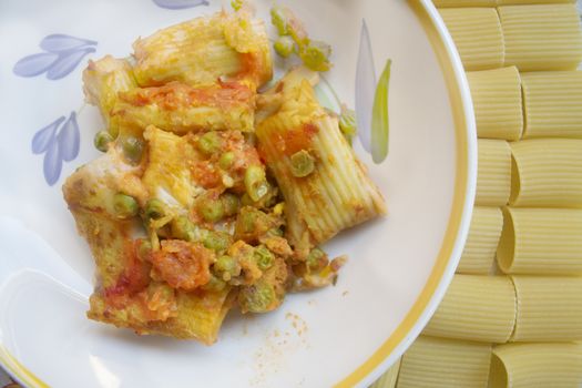 dish of baked pasta near grains of paccheri 