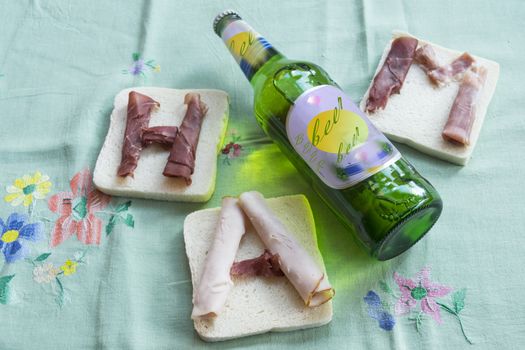 fast food with sandwich filled with ham and beer as drink