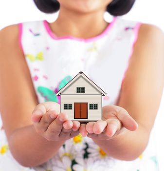 Little girl holding little house 